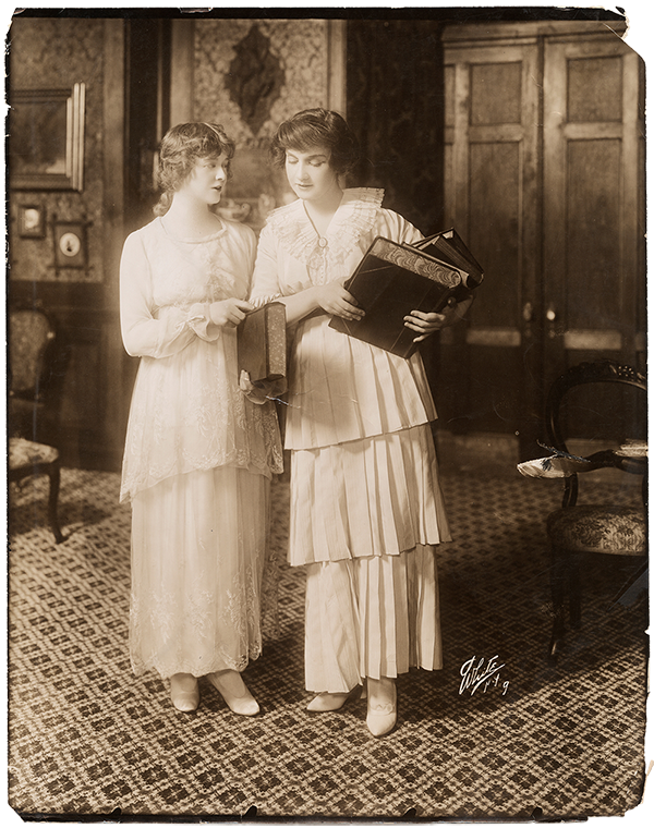 Two women holding books