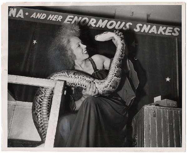 Woman and snake at circus sideshow